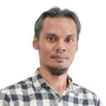 Portrait of a man with short gray-streaked hair and a goatee, wearing a blue-and-white plaid shirt, looking at the camera.