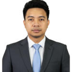 Professional headshot of a man in a dark suit and light blue tie against a white background.